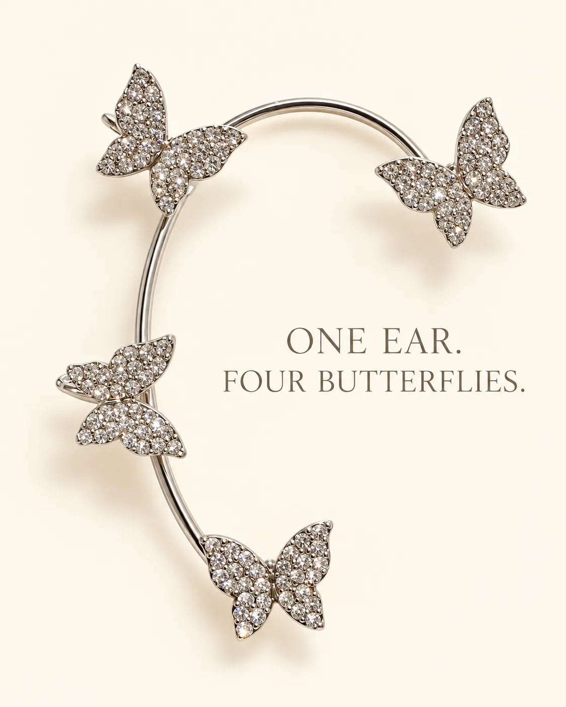 Silver butterfly ear cuff on cream with One Ear, Four Butterflies text