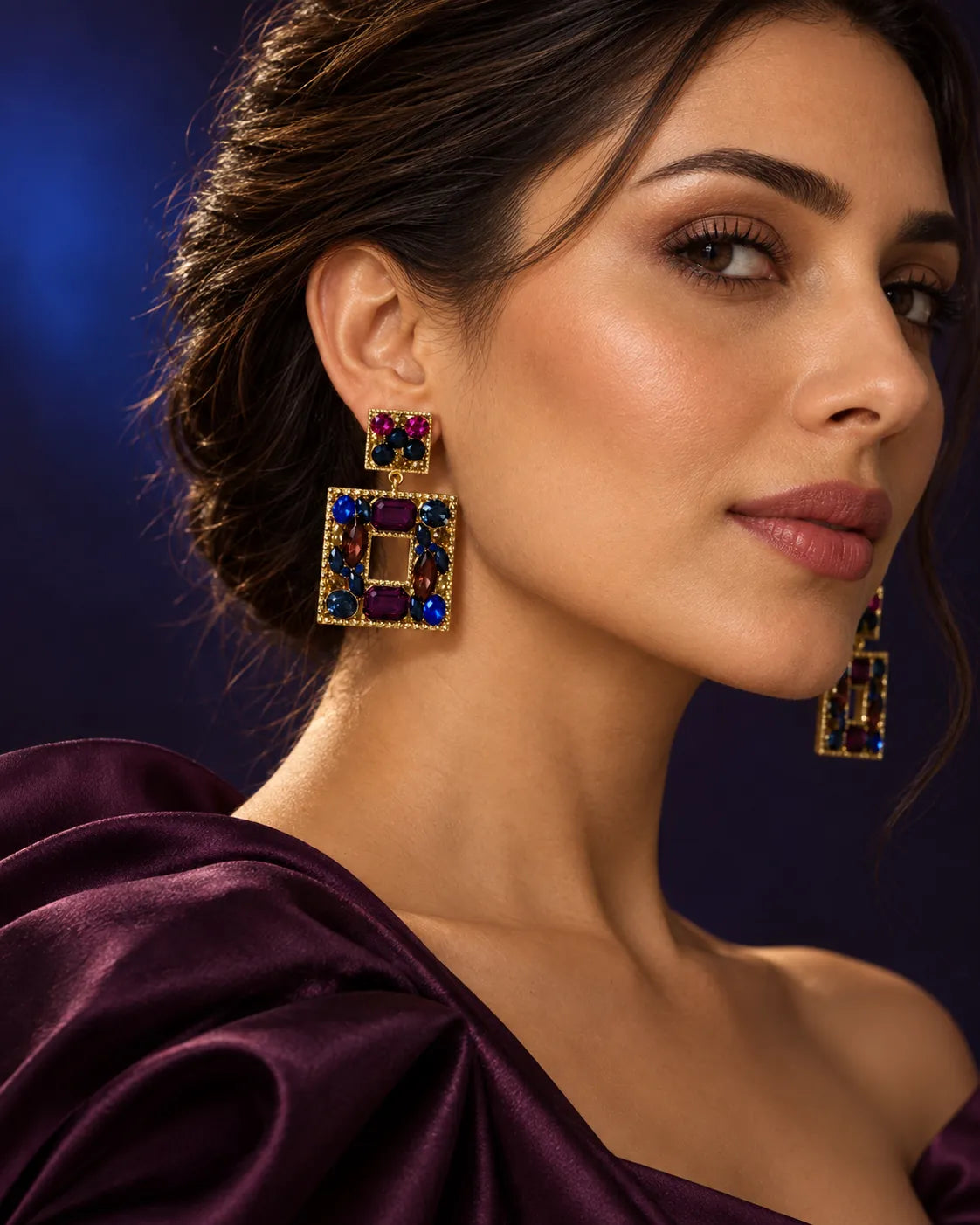 Model in plum satin against a dark backdrop wearing the crystal square earrings