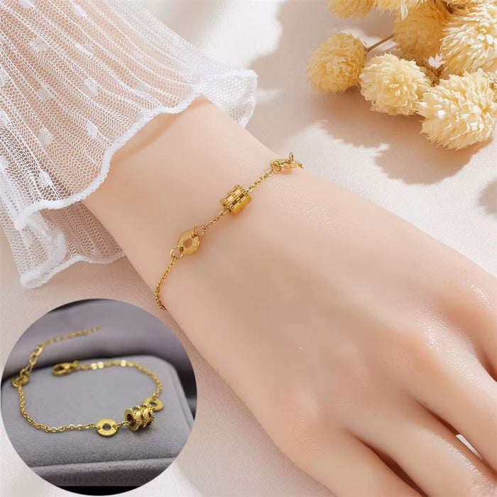 Gold bracelet on a wrist with a close-up inset, set against a soft background with flowers.