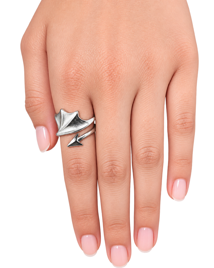 A close-up of a hand wearing a silver wrap ring with a leaf and arrow design, set against a plain white background.