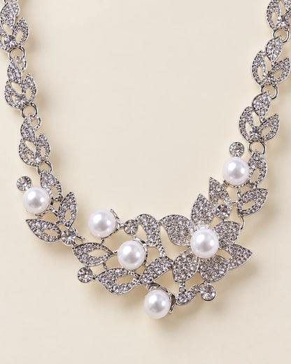 Close-up of the Ivy necklace centrepiece with rhinestone-set silver leaves and pearl-look beads