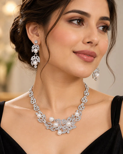 Woman in a black evening dress wearing the silver leaf and pearl bridal jewellery set