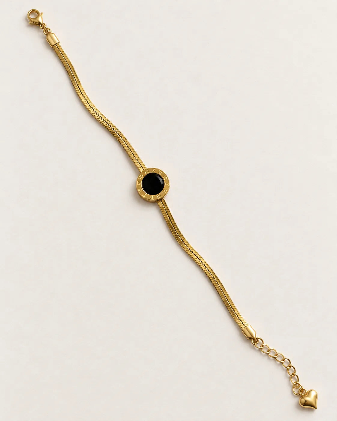 Gold and black disc bracelet laid straight on a white background