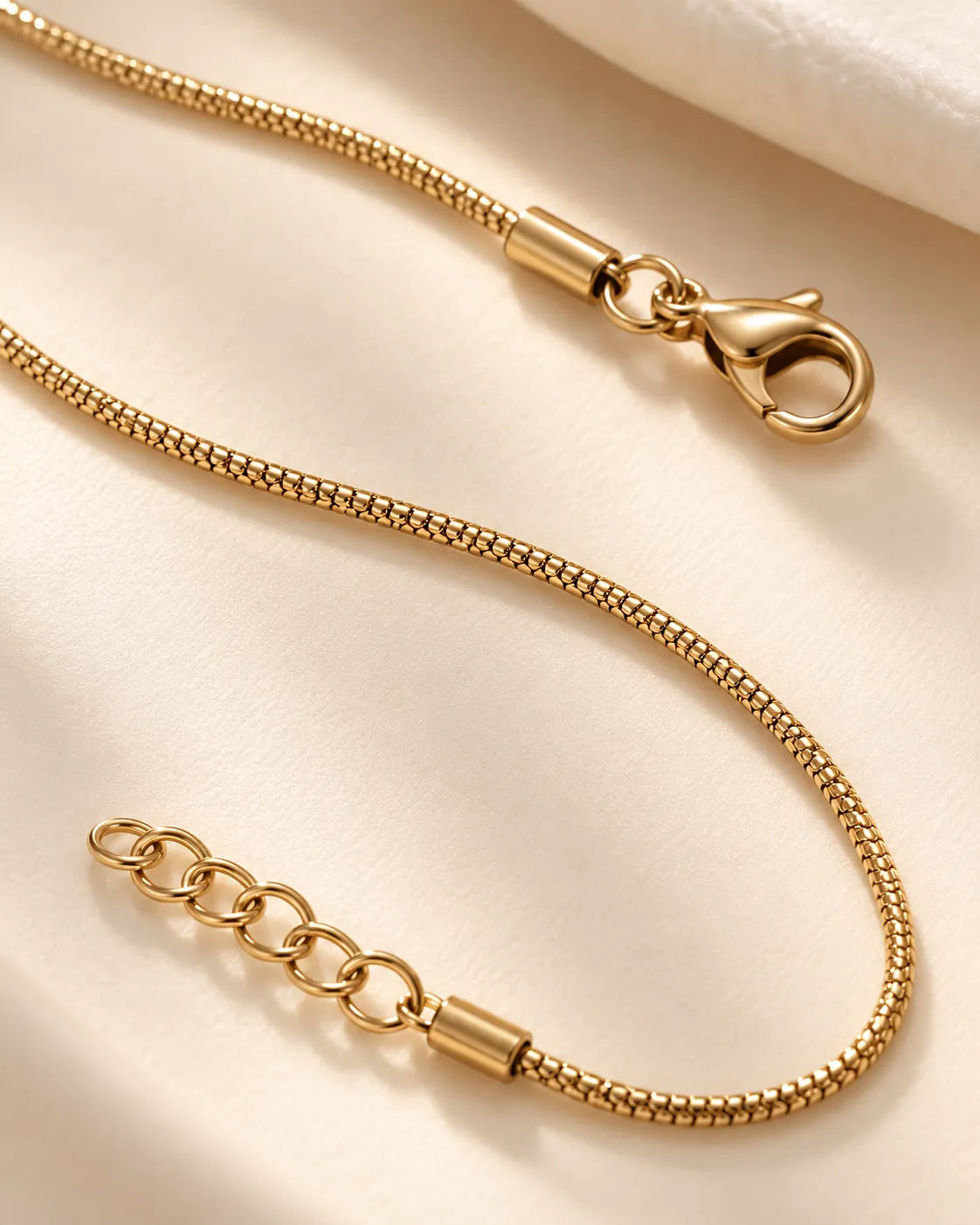 Close-up of the gold snake chain with lobster clasp and extension chain