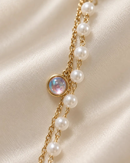 Close-up of the iridescent opal-look charm beside pearl-look beads