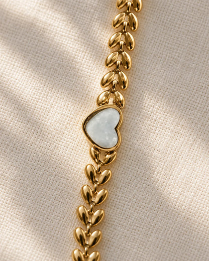 Detail of the white heart and gold leaf links on linen