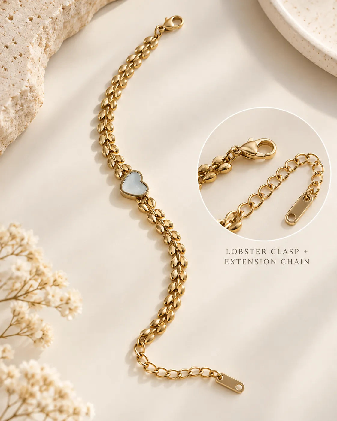 Gold leaf chain heart bracelet with an inset of the lobster clasp and extension chain