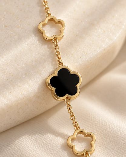Close-up of the black five-petal clover in its gold rim