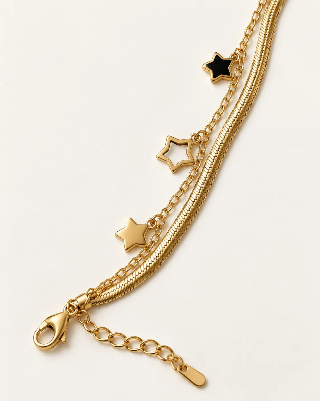 Close-up of the black star and open gold star charms with the clasp