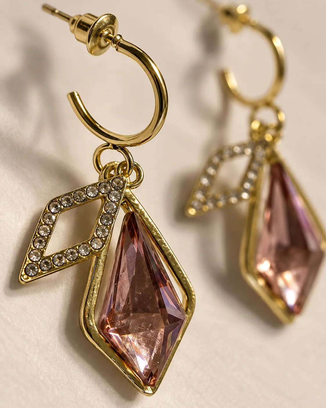 Close-up of the pavé rhombus frame and faceted rose-pink crystal