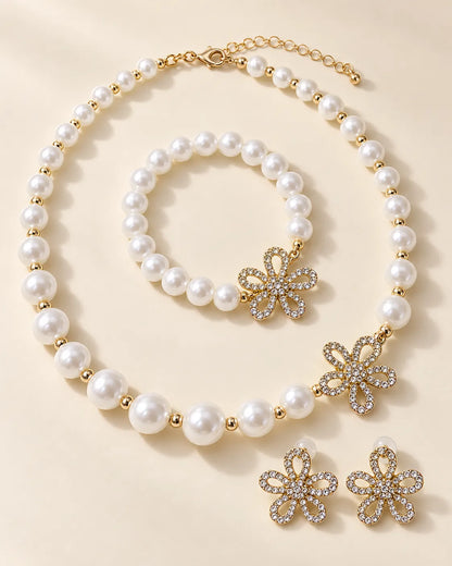 Gold flower pearl necklace, bracelet and crystal flower studs on cream
