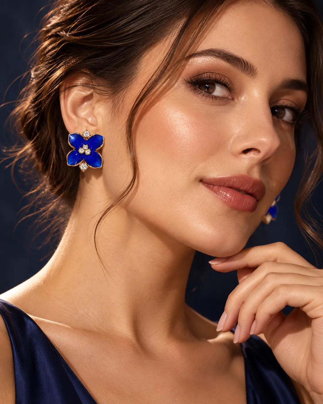 Model in a navy top wearing the cobalt blue camellia flower studs