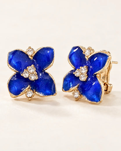 Angled pair of blue camellia studs showing the clip-style lever back