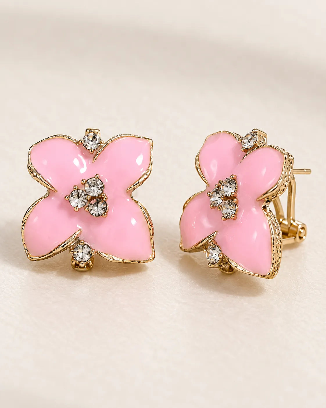 Angled pair of pink camellia studs showing the clip-style back