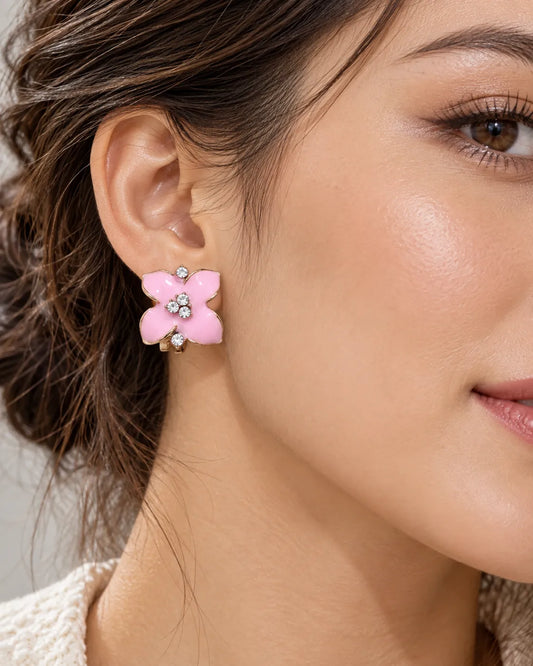 Close-up of the pink camellia flower stud worn on the ear