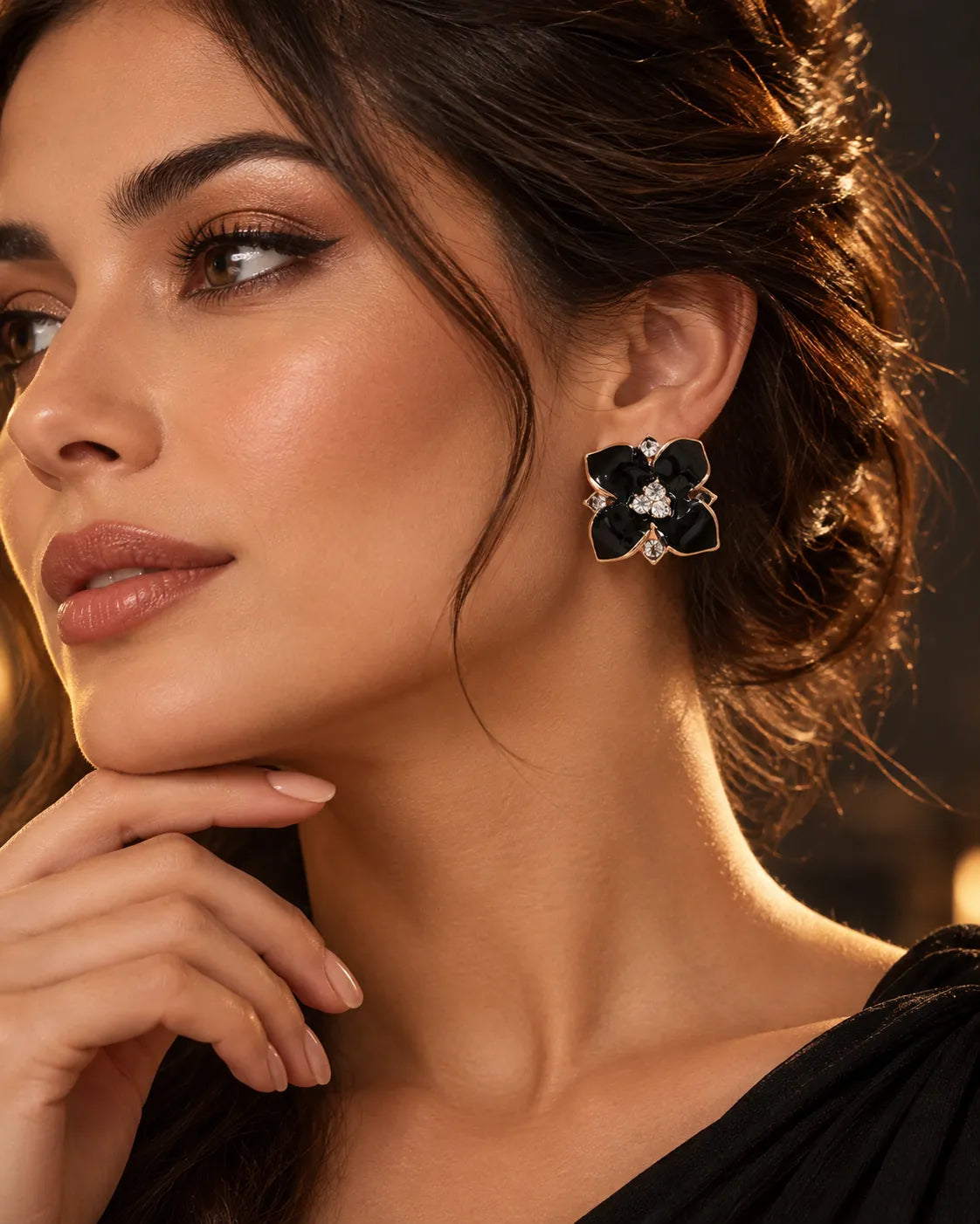 Model with hand to chin wearing the black enamel camellia studs