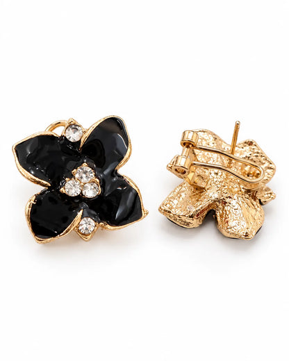 Front and gold-tone lever back of the black camellia studs on white