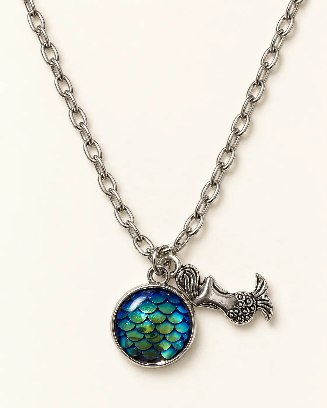 Silver mermaid scale cabochon necklace with mermaid charm on cream