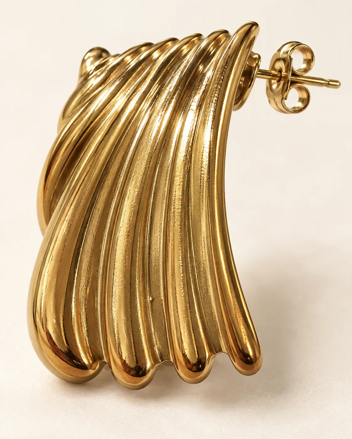 Close-up of the polished gold ribs and post on one statement stud