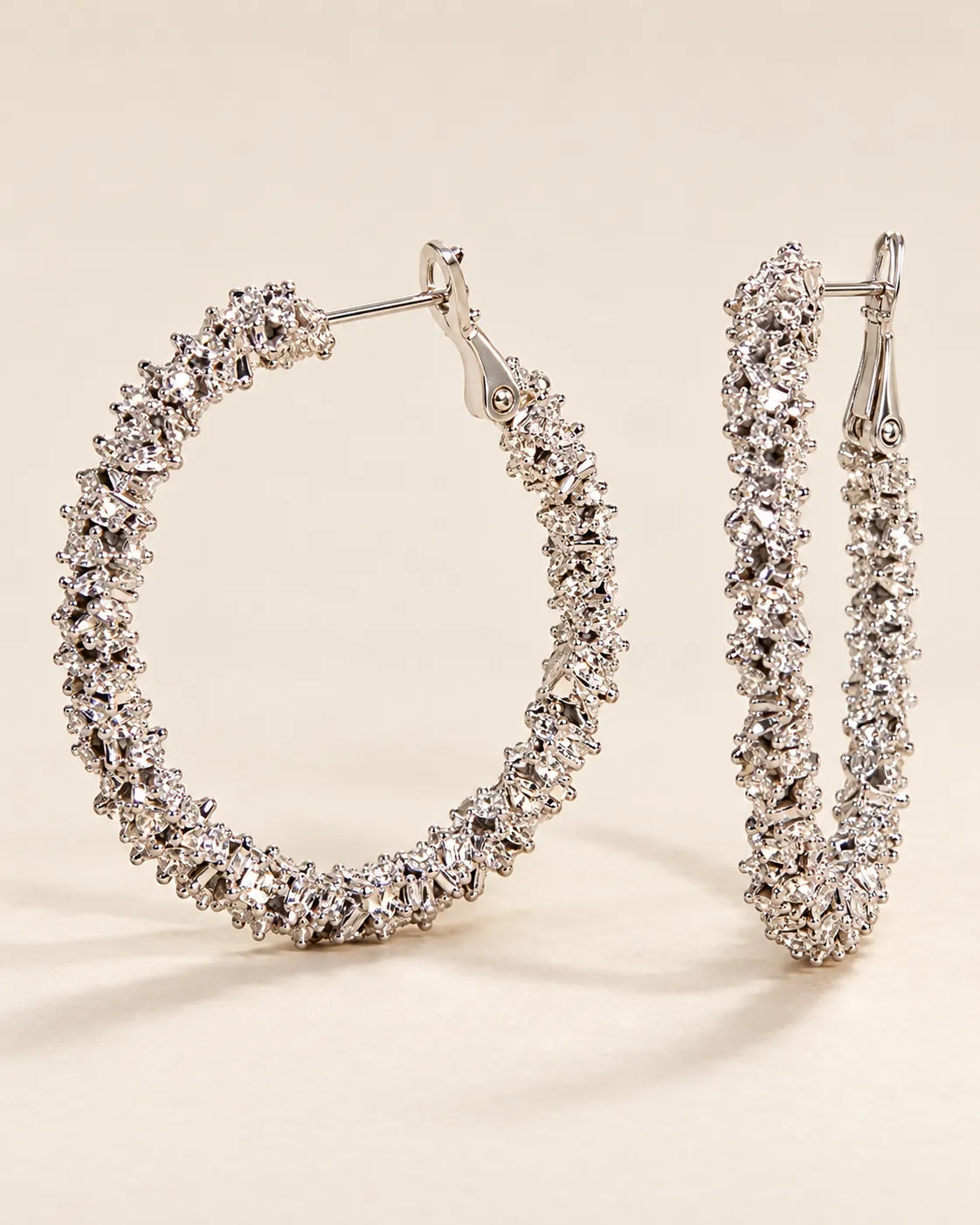Silver crystal cluster hoops shown from the front and the side