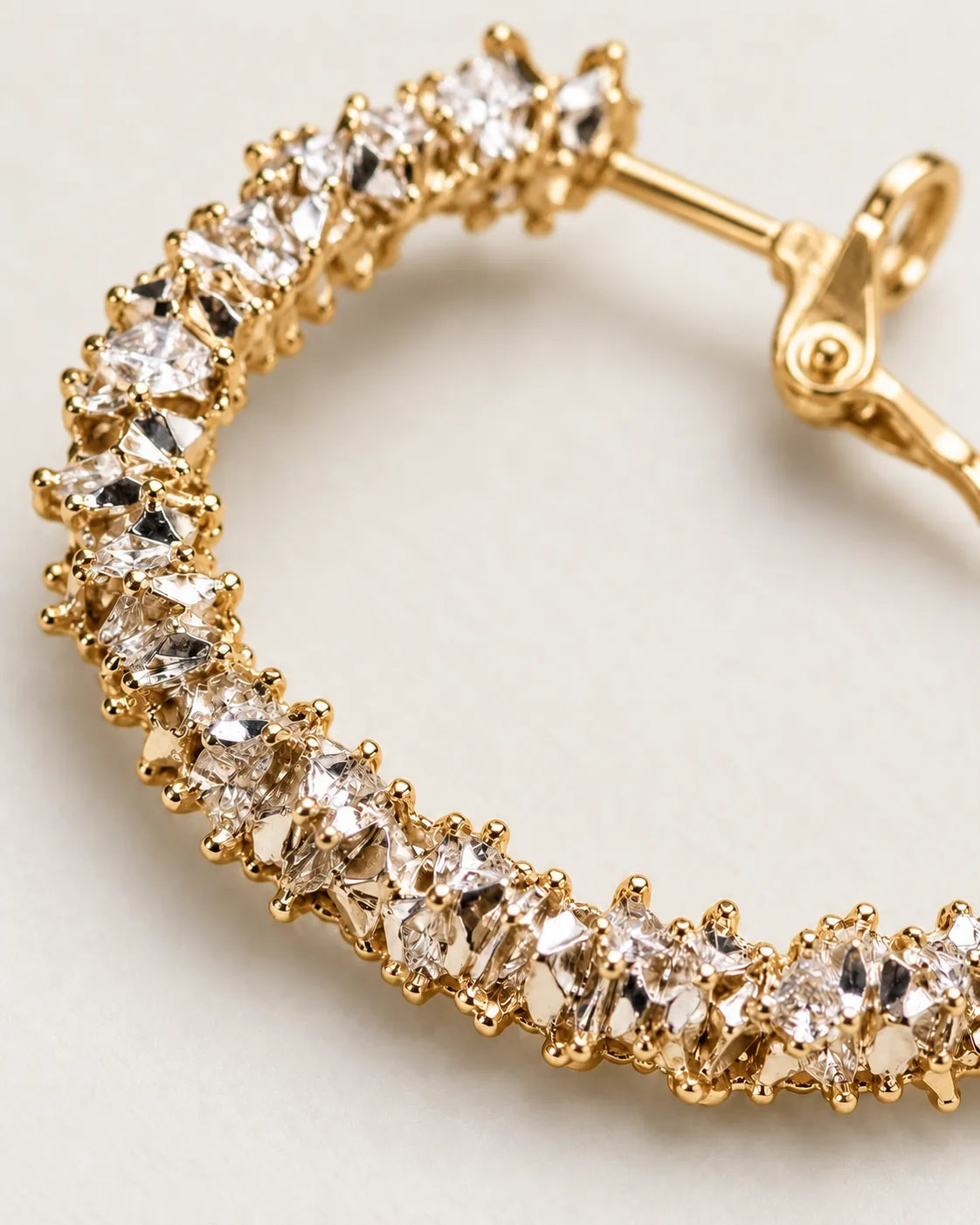 Close-up of the clustered clear crystals and post on the gold hoop