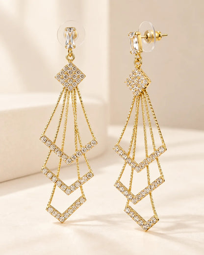 Angled view of the gold multi-layer chevron drop earrings