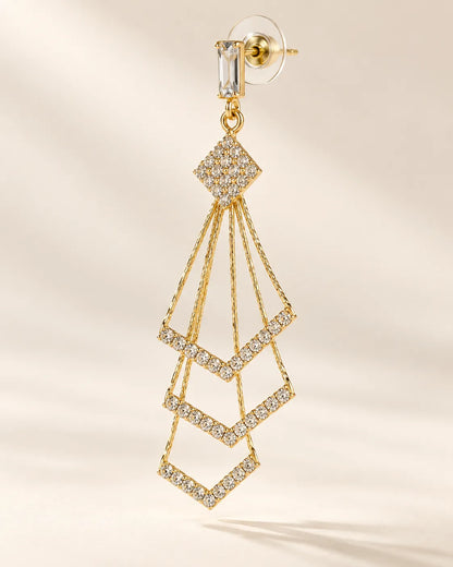 Single gold chevron tassel earring showing the crystal diamond-shaped top