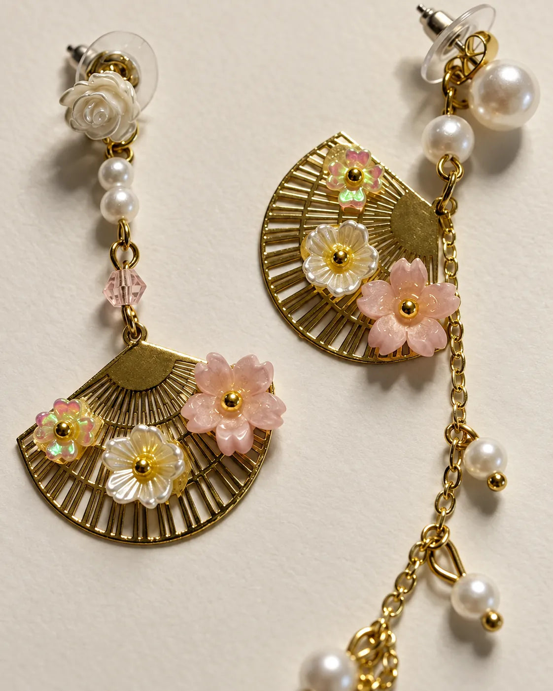 Close-up of the pink and white flowers on the textured gold fan pendant