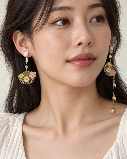 Model in a white top wearing the asymmetric fan and pearl-look earrings