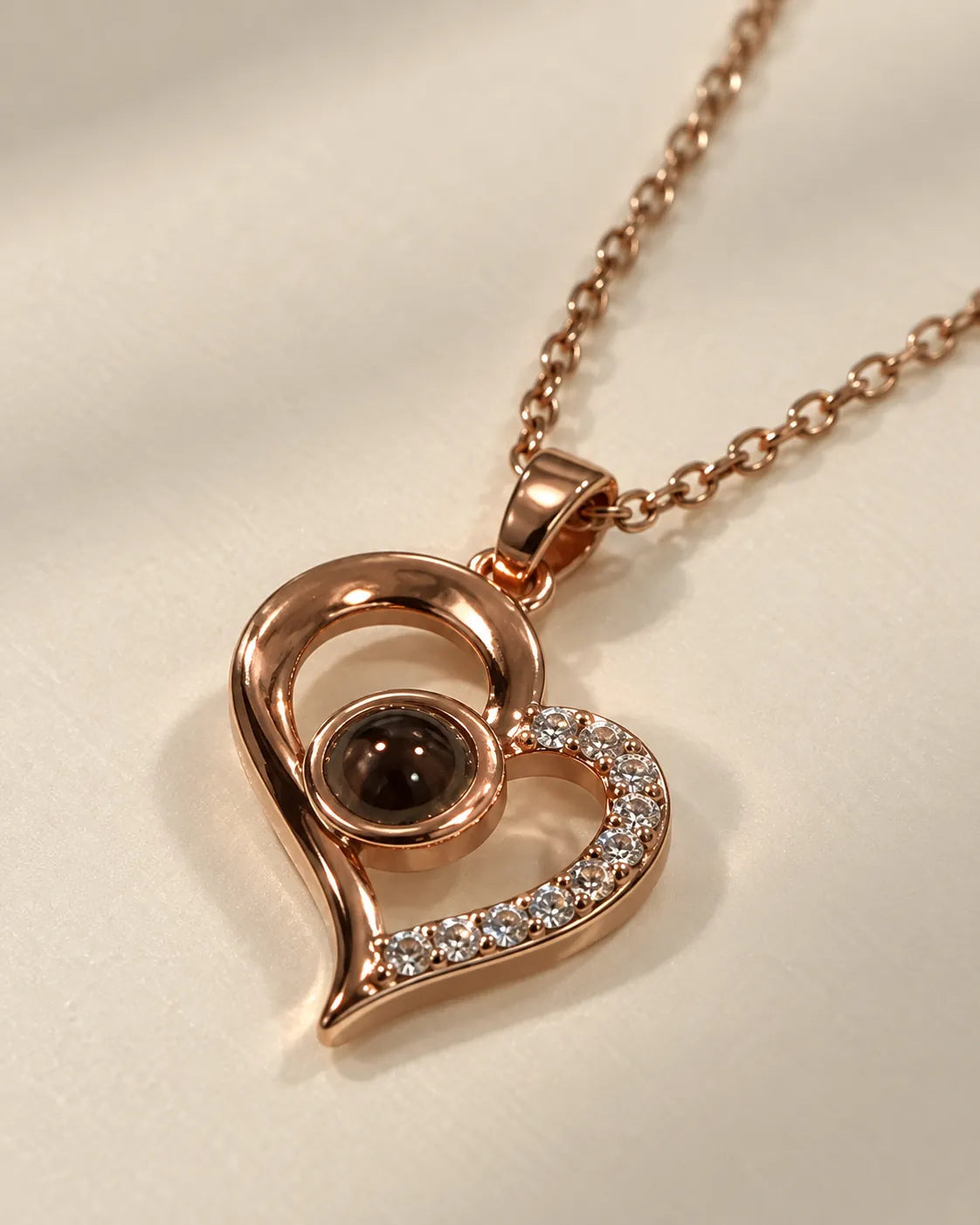 Angled view of the rose gold heart necklace showing the crystal edge