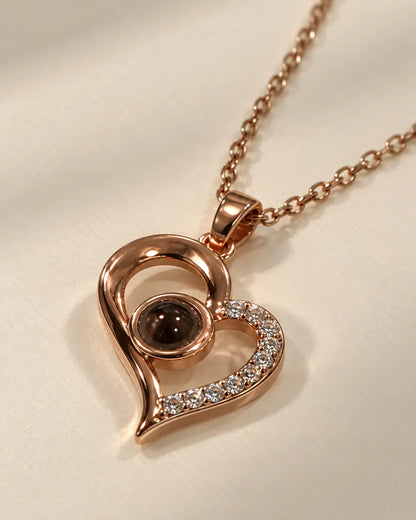 Angled view of the rose gold heart necklace showing the crystal edge