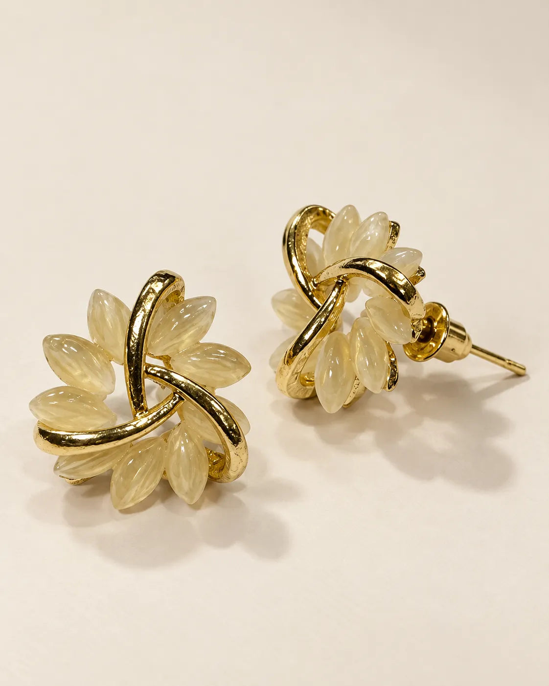 Angled view of the gold opal flower petal studs showing the post