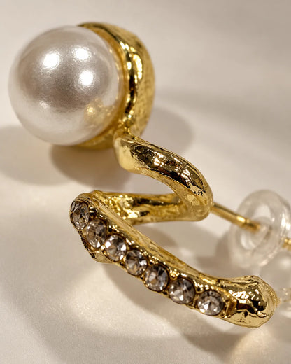Close-up of the channel-set rhinestones and pearl-look bead on the gold twist