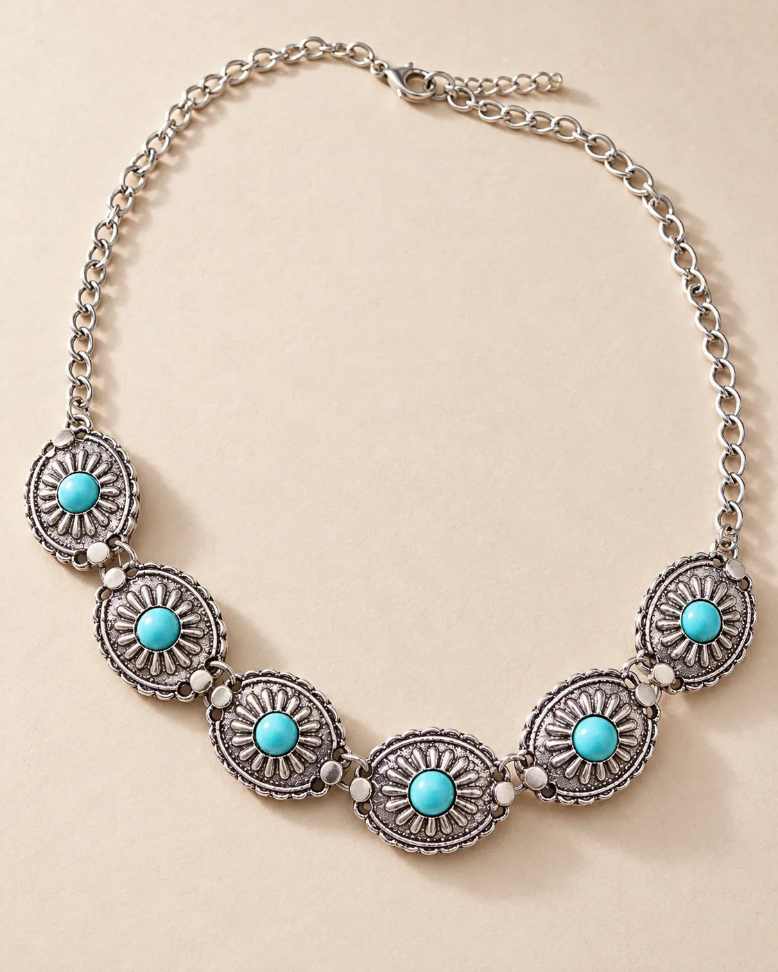 Antique silver sunburst choker with turquoise centres and extender on cream