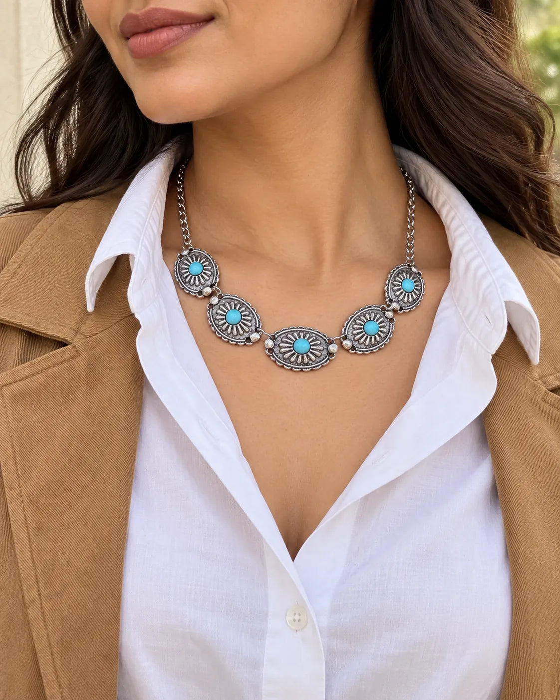 Model in a white shirt and camel blazer wearing the turquoise choker