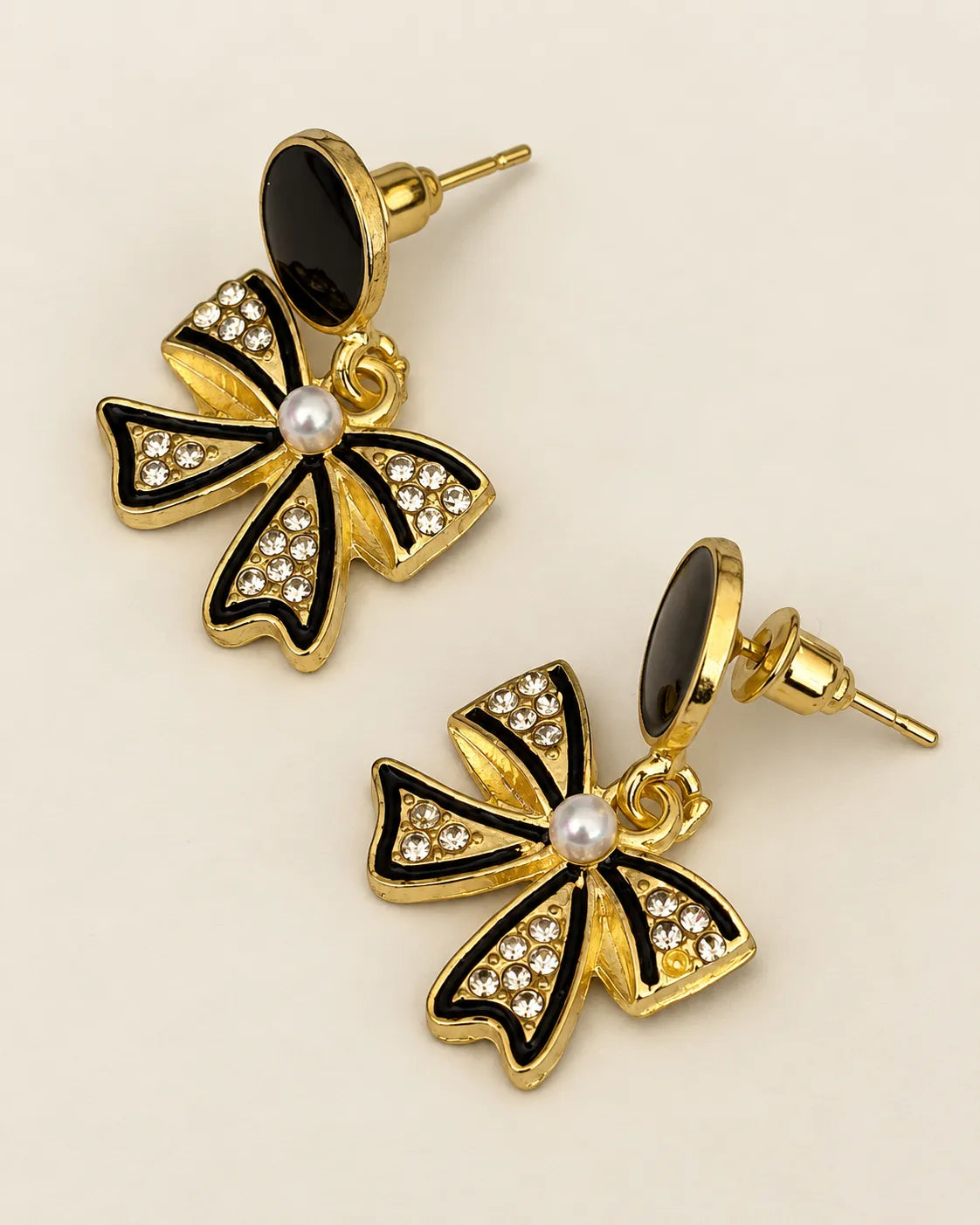 Pair of black enamel bow dangle earrings with rhinestones and pearl-look centres