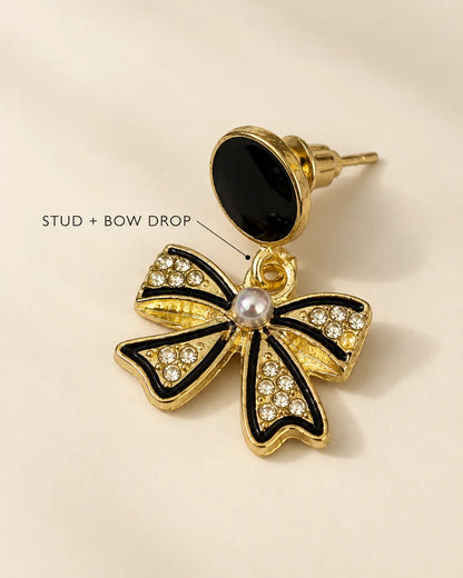 Black bow and pearl-look dangle earring on cream with Stud + Bow Drop text