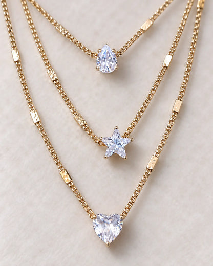 Close-up of the gold pear, star and heart crystal charms on each strand