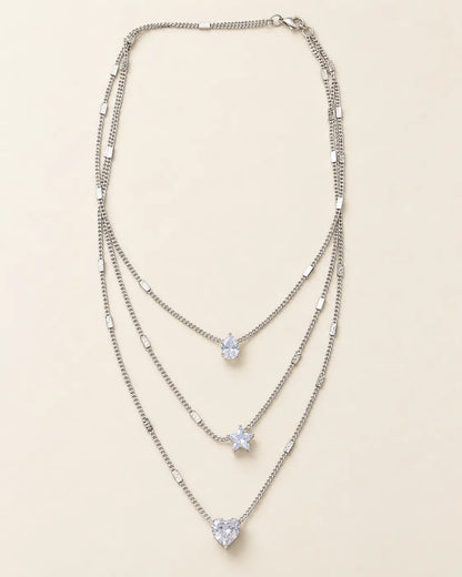 Silver-tone Celestial Sparkle three-layer crystal necklace on cream