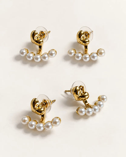 Front and angled views of the gold heart and pearl-look stud earrings
