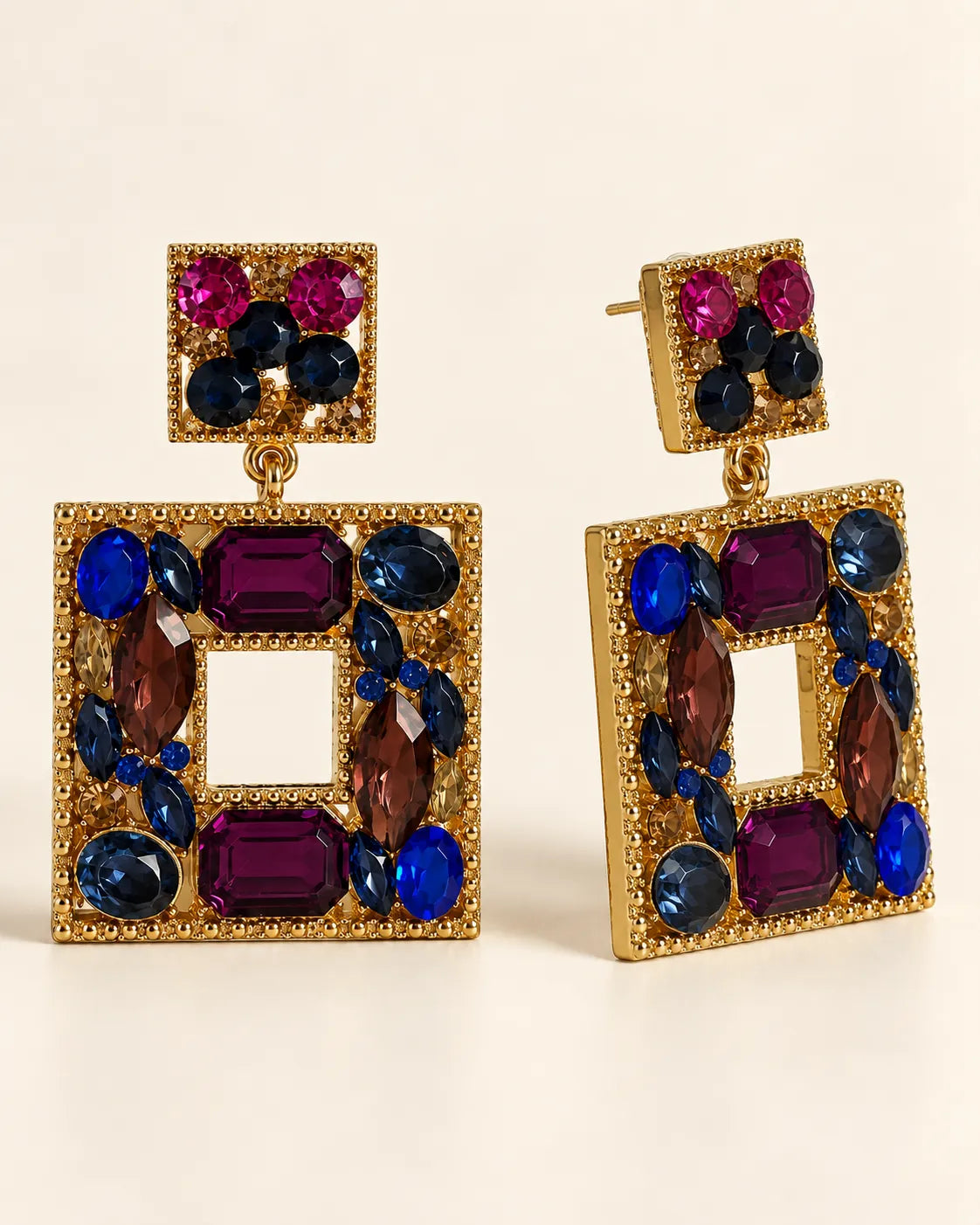 Angled view of the plum, blue and amber crystal square drop earrings