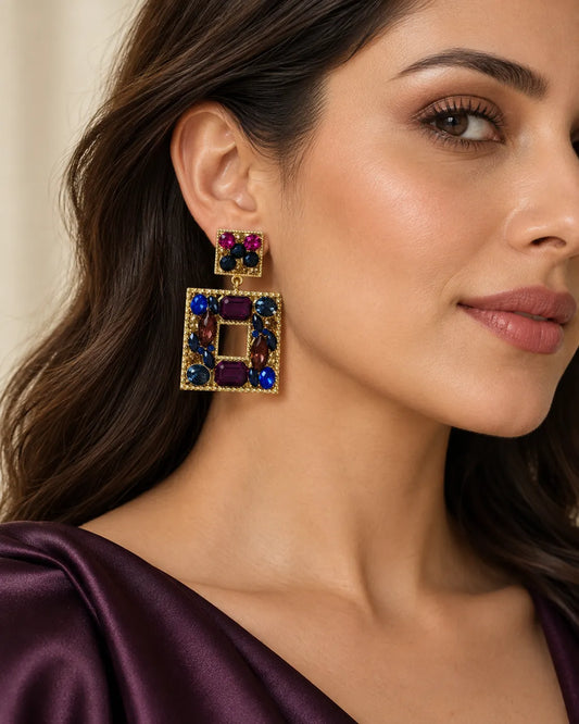 Model in plum satin wearing the Celeste crystal square earrings