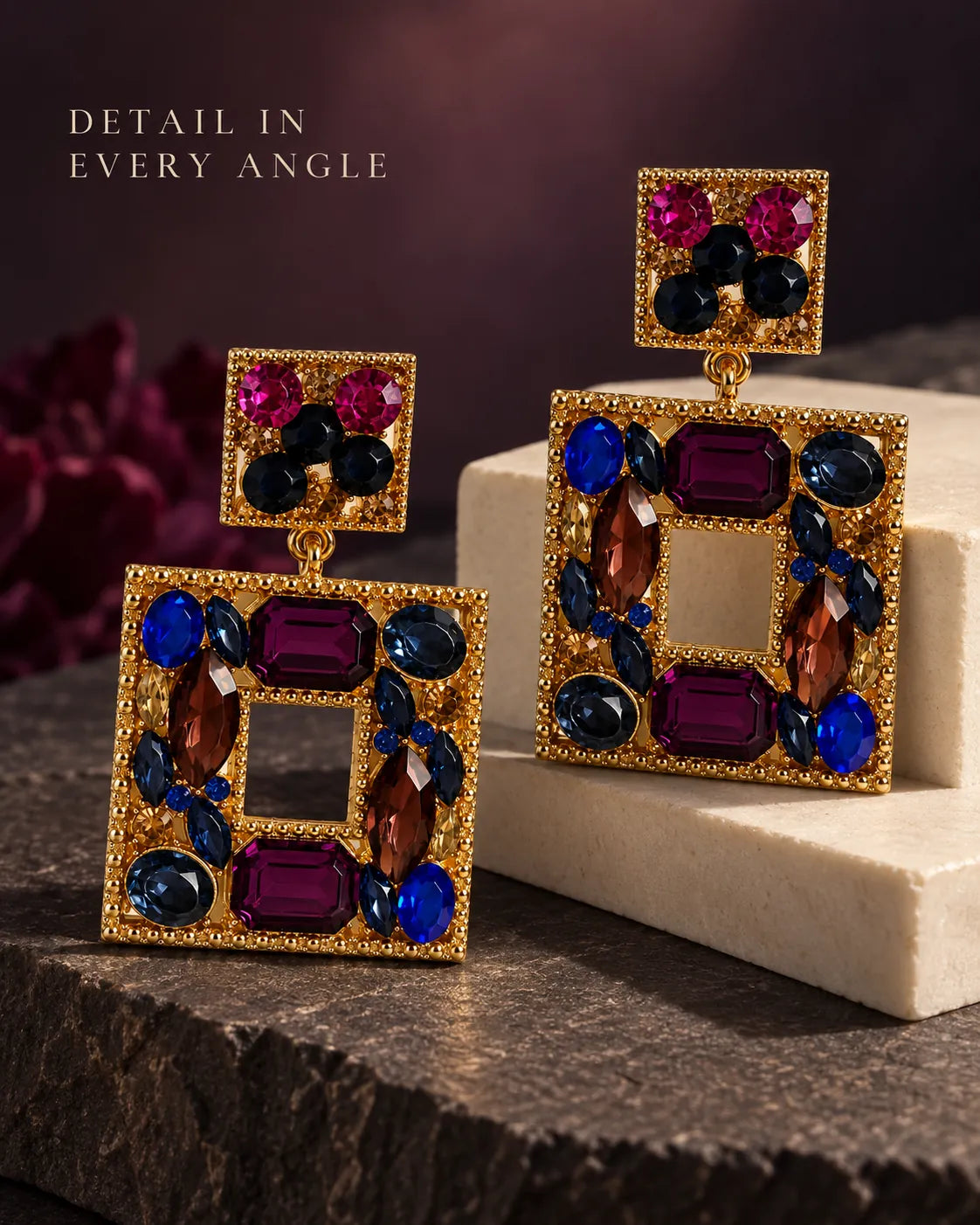 Plum jewel-tone square drop earrings on a dark stone surface