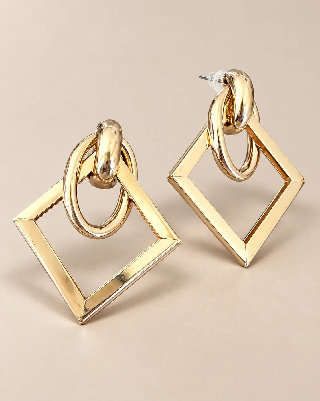 Angled view of the gold-tone double-loop and open square drop earrings