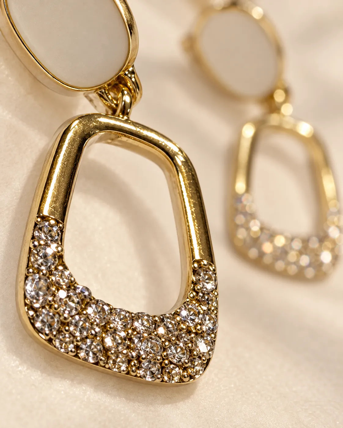 Close-up of the white enamel stud and pavé cubic zirconia band on the drop