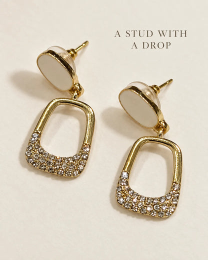 White stud drop earrings on a cream card with A Stud With A Drop text
