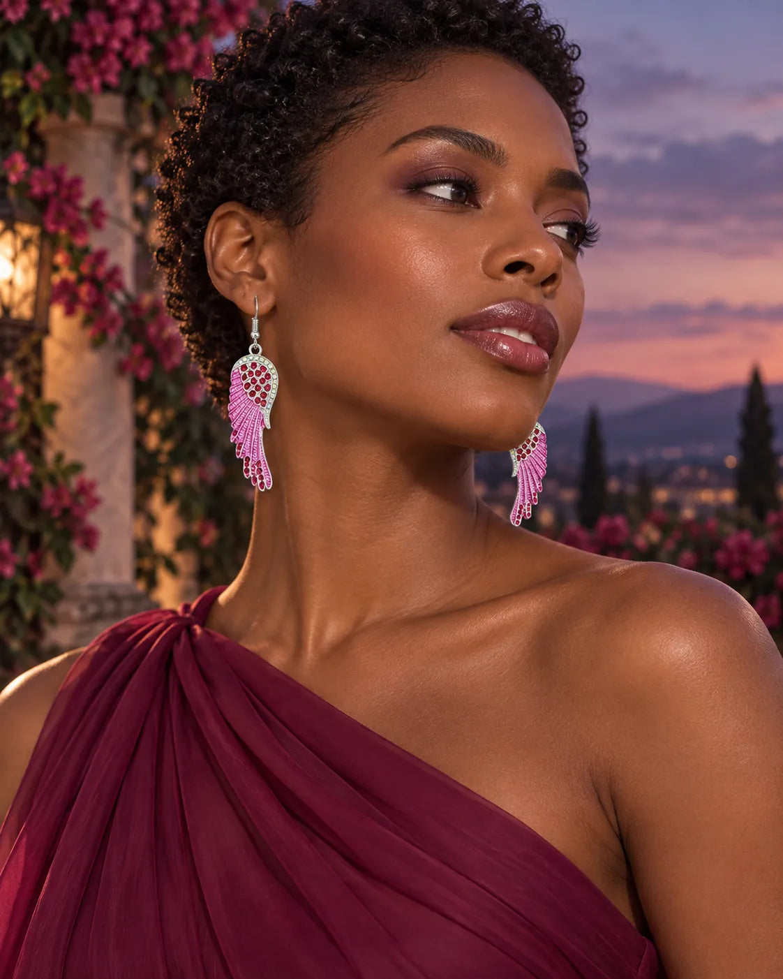 Side profile of a model in magenta wearing the pink angel wing crystal earrings