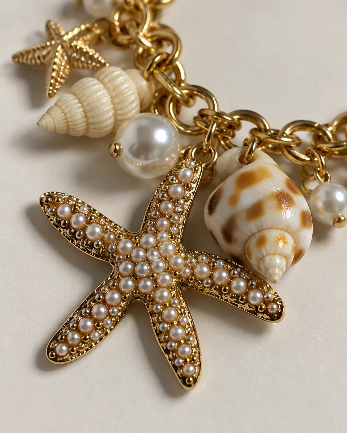 Close-up of the pavé starfish, spiral shells and pearl-look beads