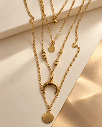 Close-up of the gold crescent moon, disc drop and bead charms