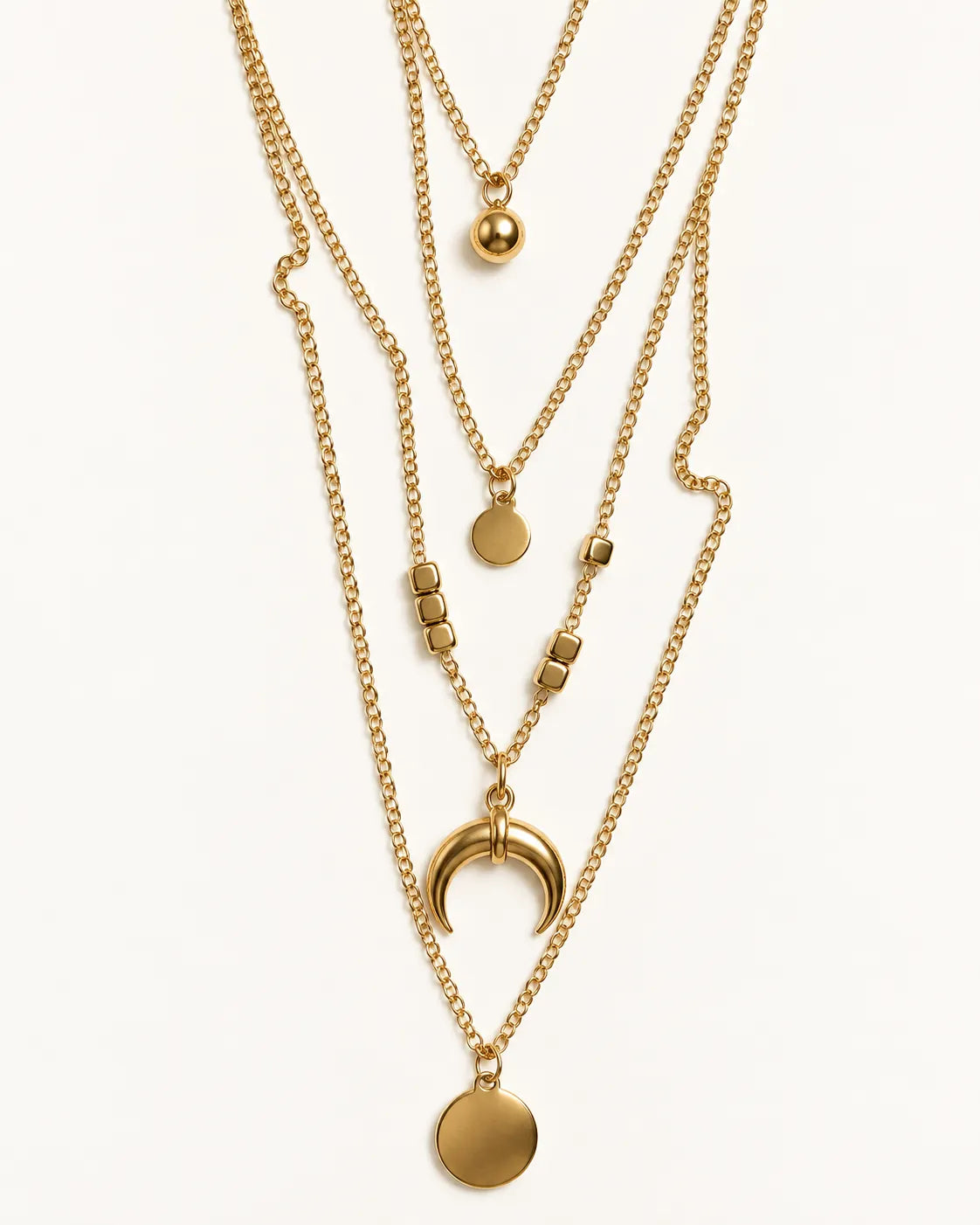 Gold-tone layered crescent moon necklace laid out on white